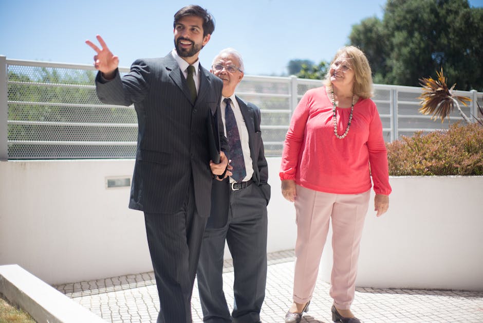 Real estate agent showcases property to a senior couple outdoors on a sunny day.